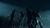 a group of people standing in a dark room
