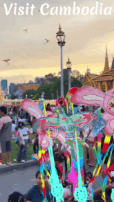 a poster for visit cambodia with a crowd of people