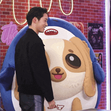 a man is standing next to a stuffed animal that says leap day
