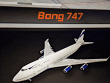 a model of a bong 747 airplane on a black background