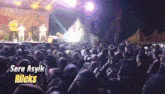 a crowd of people watching a concert with the words seru asyik rileks on the bottom