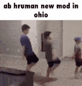 a group of young boys are dancing in a living room .