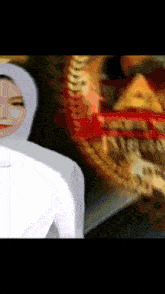 a woman in a white hijab is standing in front of a blurred image