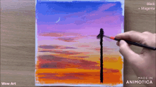 a person is painting a sunset on a canvas with black and magenta paint