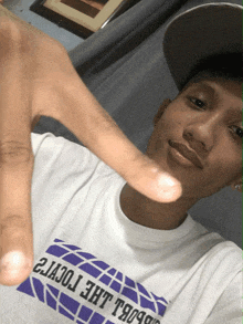 a young man wearing a t-shirt that says ' 2ja30j3ht ' on the front