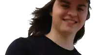 a young man with long hair wearing a hat and a black shirt smiles