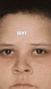 a close up of a person 's face with the word why written on the forehead