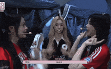 a girl in a red shirt with the number 8 on it is talking to two other girls