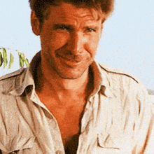 a close up of a man 's face with a shirt off