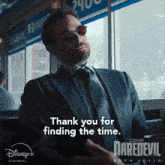 a man in a suit and tie says thank you for finding the time on a daredevil born again poster