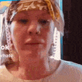 a close up of a woman wearing a head scarf .