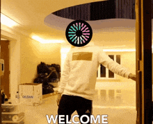a man is standing in front of a gildan box and says welcome