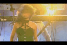 a woman in a black corset is standing in front of a piano keyboard