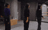 a woman in a purple shirt has a sticker on her back that says ' a '