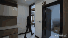 a woman is walking through a hallway with the words made in animotica at the bottom