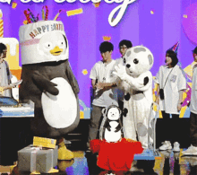 a group of mascots are standing in front of a sign that says happy birth