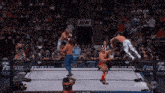 a group of men are wrestling in a ring with a sign that says aew in the background