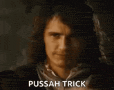 a man with long hair is making a middle finger gesture and says pussah trick .