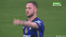 a soccer player wearing a blue and black jersey with the number 1 on it