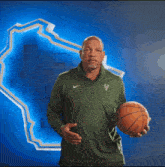 a man wearing a green nike shirt is clapping