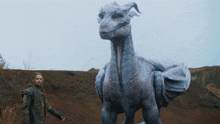 a man standing next to a large white dragon with horns