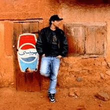 a man is standing in front of a pepsi sign on a wooden door .