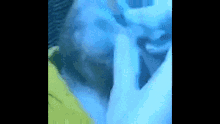 a close up of a person 's face with blue foam coming out of it