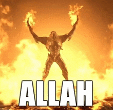 a man is standing in front of a fire with his arms outstretched and the word allah written on it .