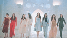 a group of women standing next to each other in a line holding hands