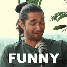 a man in a green shirt is making a face and the word funny is above him