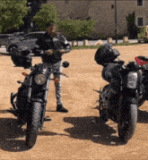a man standing next to a motorcycle that says ' samurai ' on the back