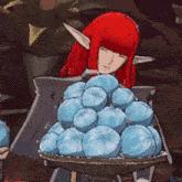a woman with red hair is holding a tray of blue balls