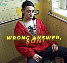 a man in a red hoodie sits in a bathroom with the words wrong answer son written above him
