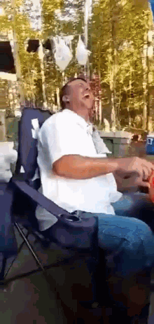 a man sitting in a chair with his mouth open