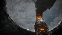 a very tall building with smoke coming out of it is surrounded by snow