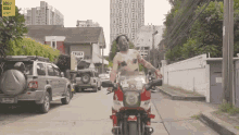 a man riding a motorcycle with a sign that says gogo goal on it