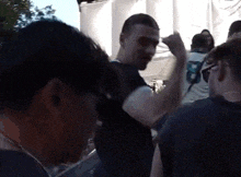 a man wearing a shirt with the number 8 on it stands in a crowd