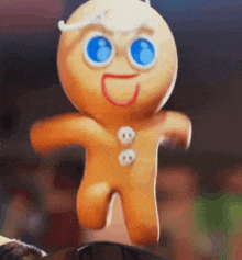 a gingerbread man with blue eyes is jumping in the air while standing on a table .