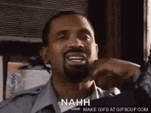 a man with a beard is making a funny face and saying nahh .