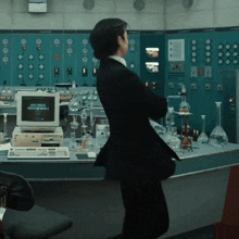 a man in a suit stands in front of a computer that says ' space shuttle ' on the screen