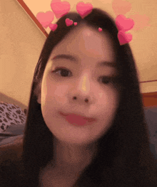a girl with hearts on her head is smiling