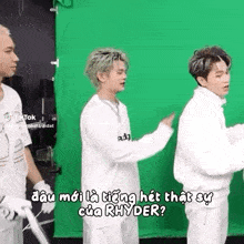 a group of young men are standing next to each other on a green screen .