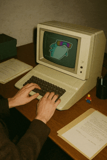 a person is typing on an old fashioned computer