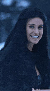 a woman wearing a choker and a black jacket has the letters vs on the bottom right