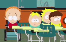 a group of south park characters sit at their desks