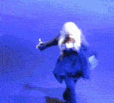 a woman in a blue dress is dancing on a blue background