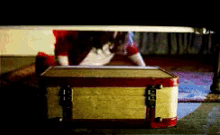 a pixelated image of a person peeking out from under a bed