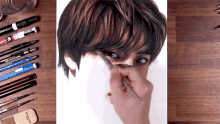 a person is drawing a man 's face with a pencil and a pencil eraser that says staedtler