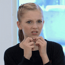 a woman making a funny face with her hands on her face