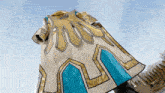 a white and gold item with a blue stripe on the side